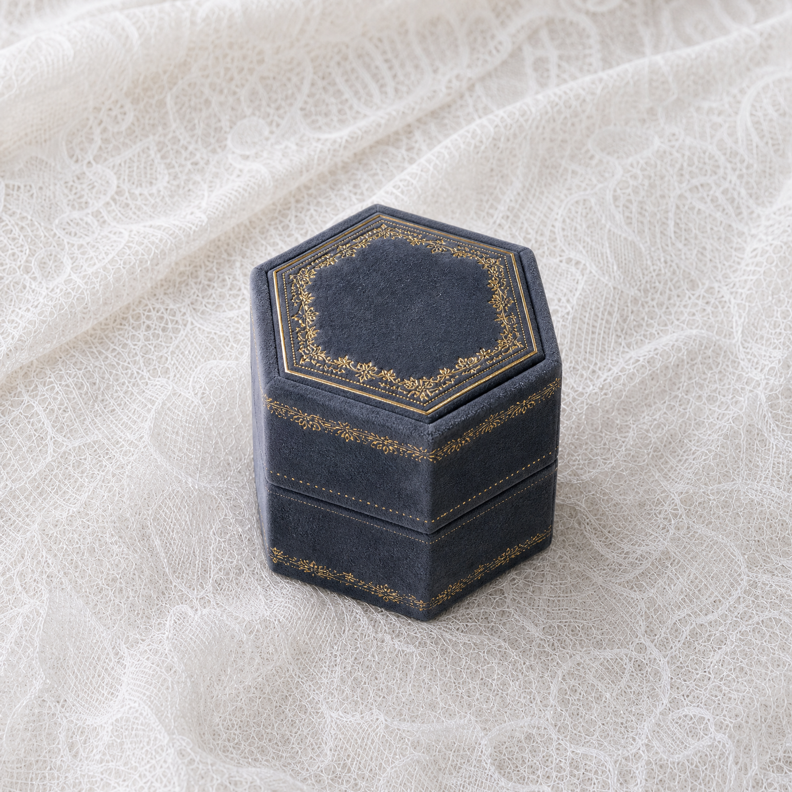Antique Slate velvet hexagonal ring box with gold foil detailing, shown closed
