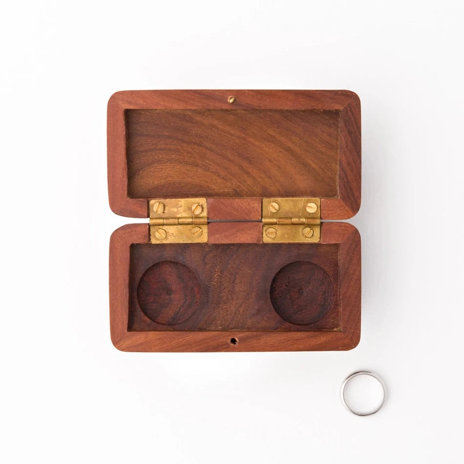 Wooden dual ring box with brass hinges on a white background