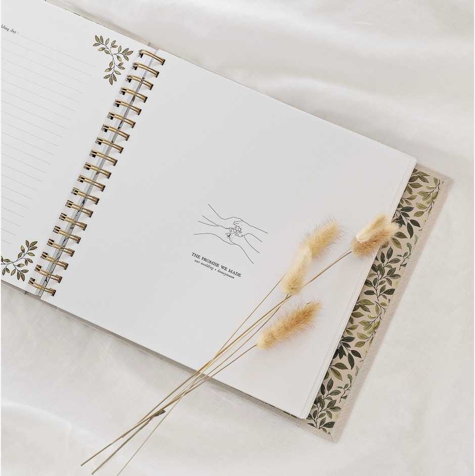 Open As We Grow book by Korie Hanson. with decorative pages and dried plants on a white surface