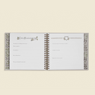 Open As We Grow book with decorative pages on a light beige background