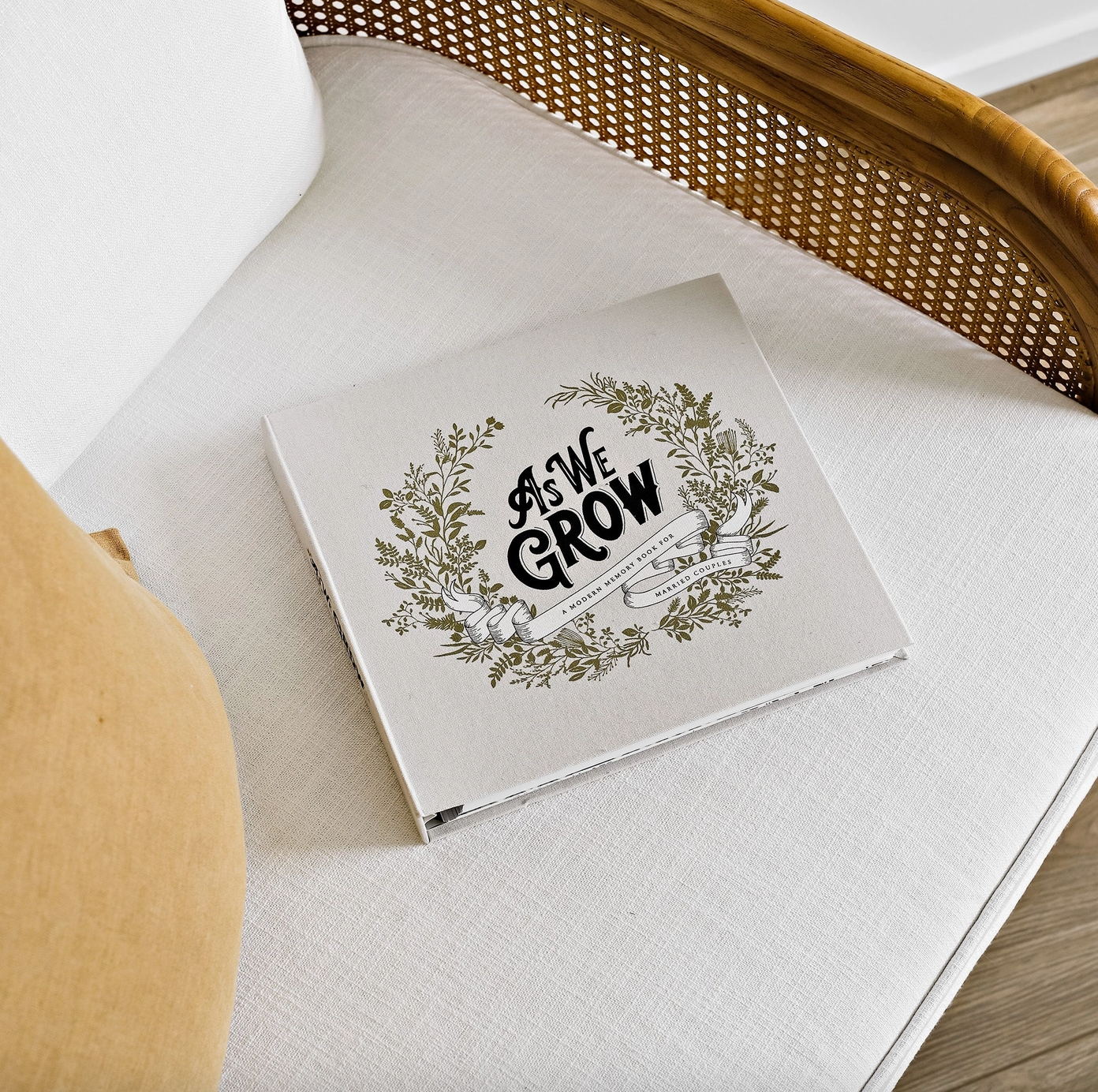 As We Grow A Memory Book for Married Couples sitting on white linen sofa