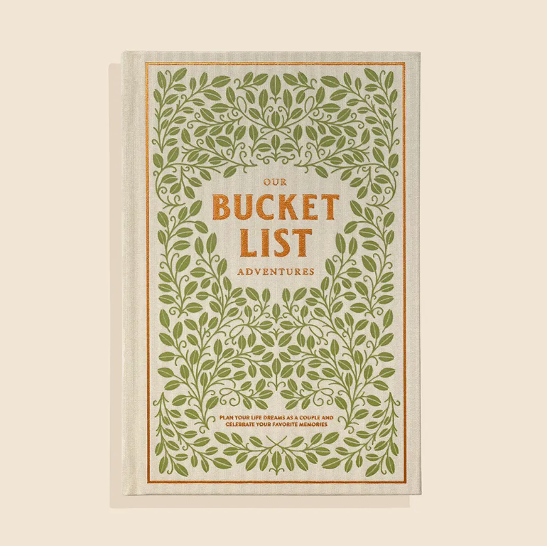 Book titled 'Our Bucket List Adventures' with green leafy design on a beige background