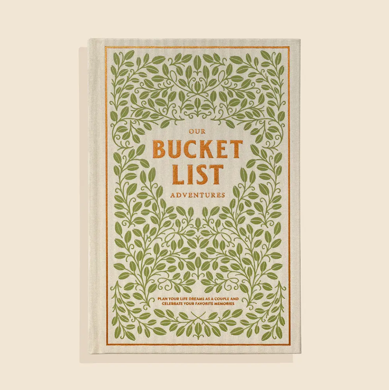 Book titled 'Our Bucket List Adventures' with green leafy design on a beige background