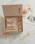 Linen covered heirloom keepsake box by For Keeps with suede keepsake pouches, a ring box and a perfume bottle.