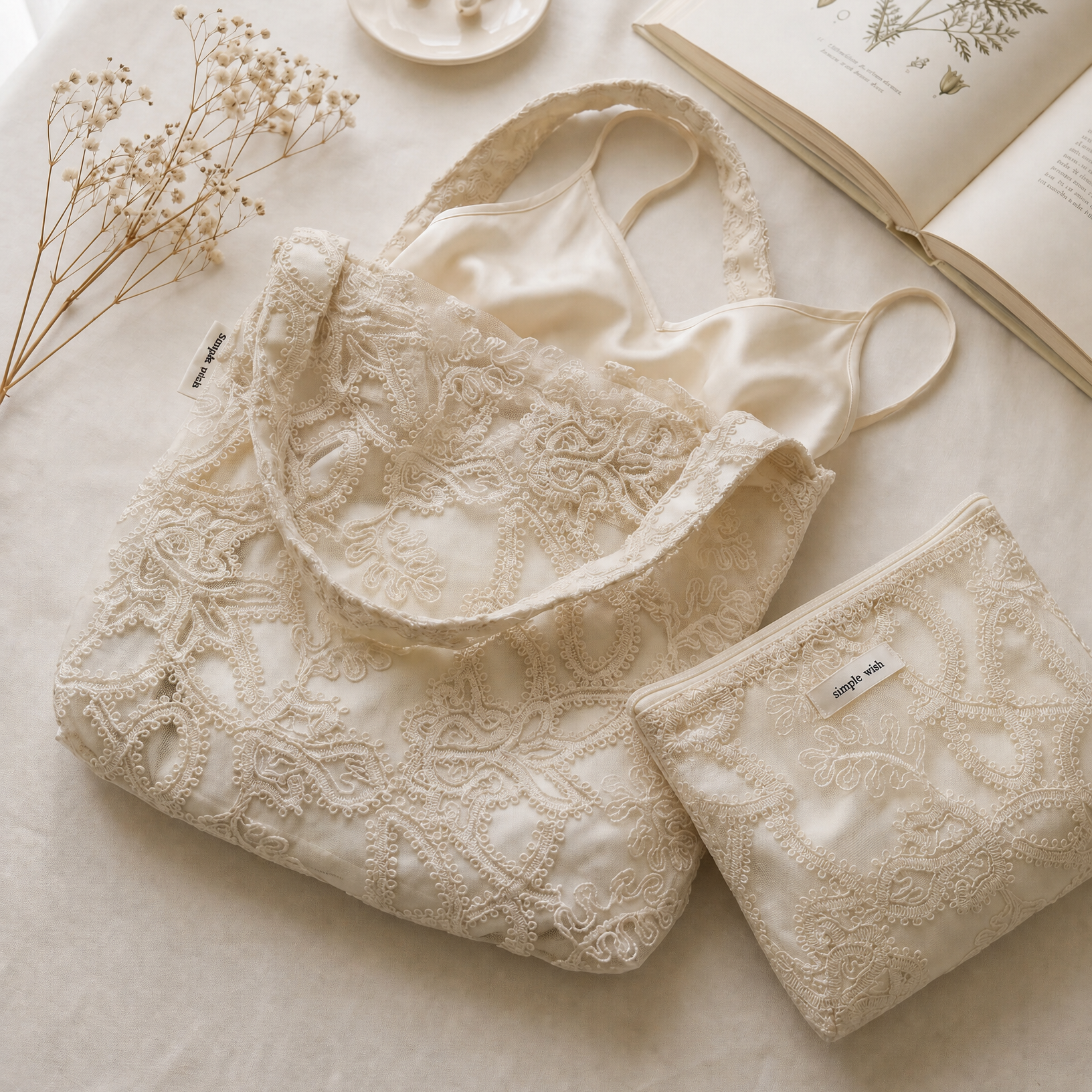 Ivory embroidered bridal tote and pouch with a satin slip and baby's breath