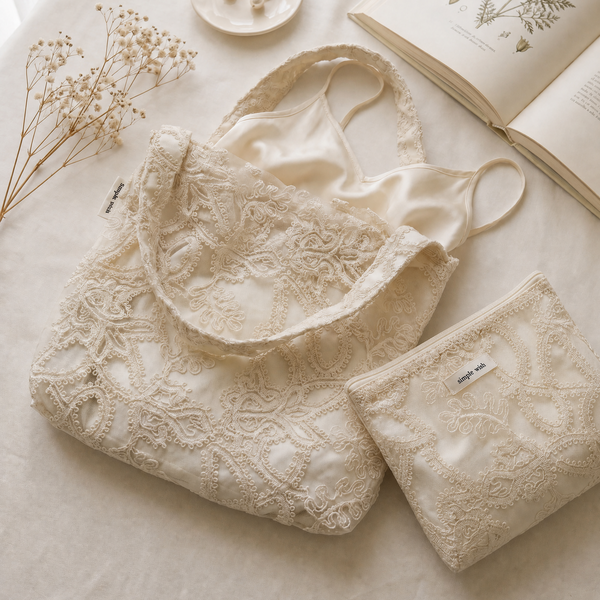 Ivory embroidered bridal tote and pouch with a satin slip and baby's breath
