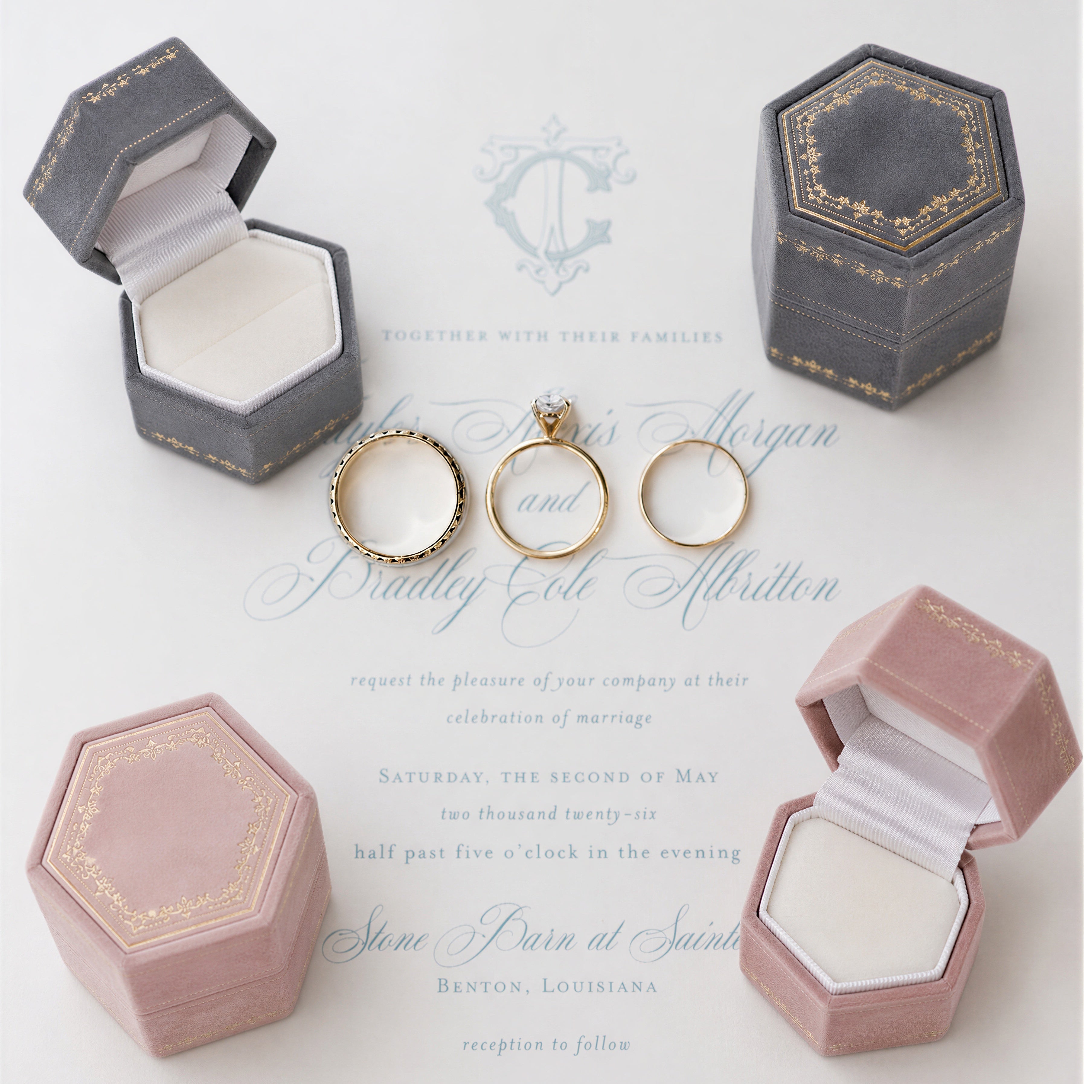 Three gold rings in hexagonal velvet ring boxes on a white background with wedding invitation text.