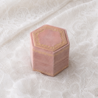Antique Rose velvet hexagonal ring box with gold foil detailing, shown closed