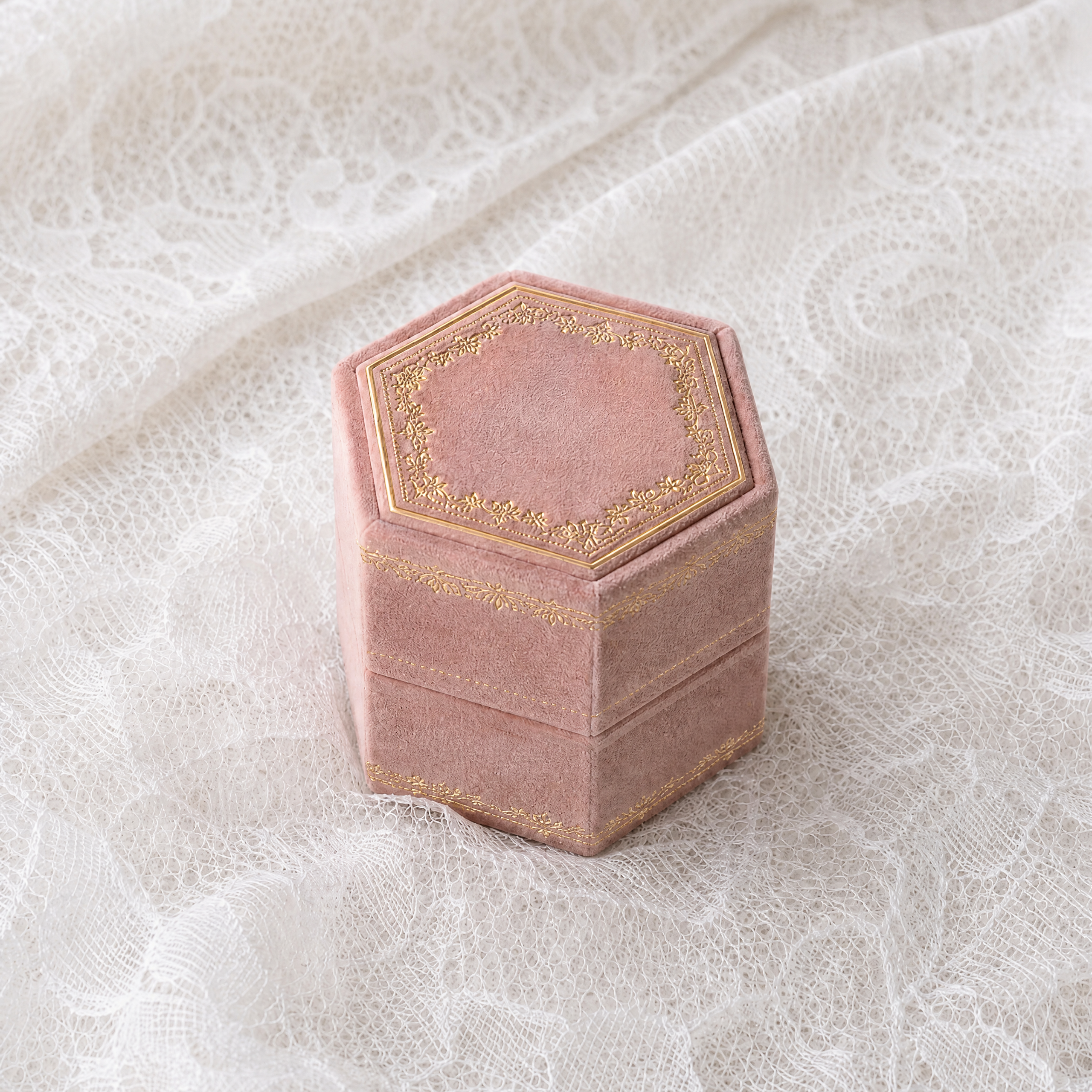 Antique Rose velvet hexagonal ring box with gold foil detailing, shown closed
