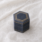 Antique Slate velvet hexagonal ring box with gold foil detailing, shown closed