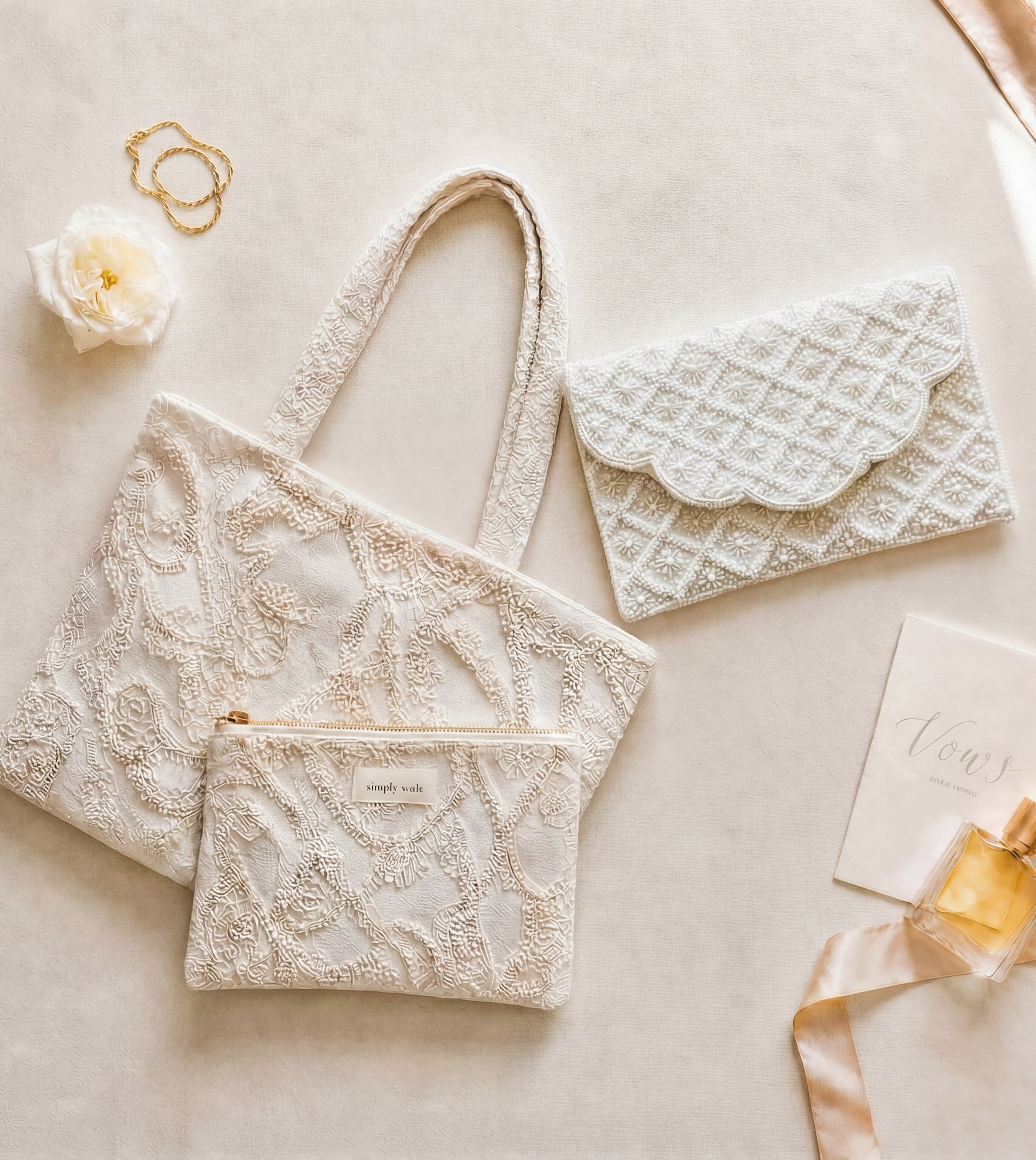 The For Keeps beaded clutch and embroidered heirloom tote in a wedding day flat lay