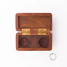 Wooden dual ring box with brass hinges on a white background