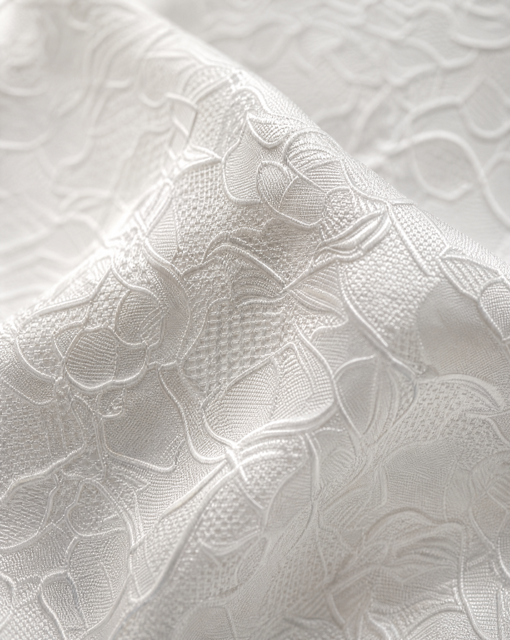 Close-up detail of the exclusive breathable bonded lace fabric a wedding dress bag.